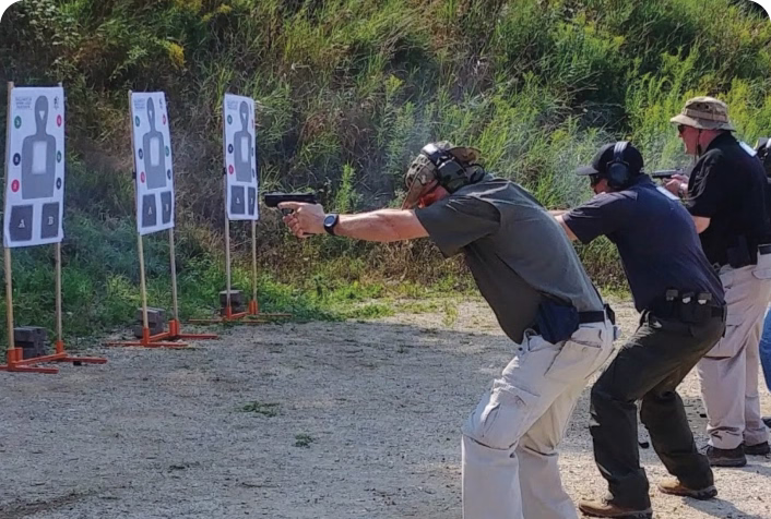 An instructor teaching a group of students at the range.