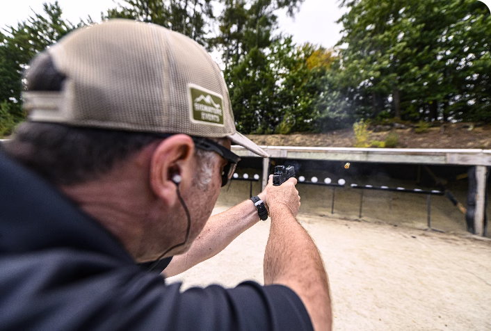 A man practices firearm safety at the range.